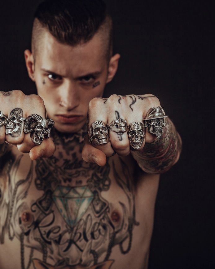 Portrait of Jonah Kress, blackwork tattoo artist, showing his rings