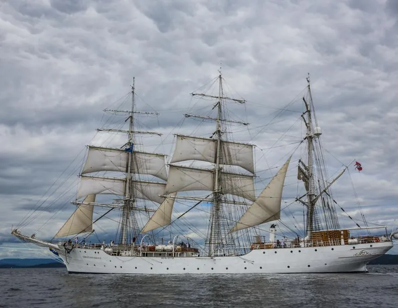 Classic tall-masted sailing ship on open water