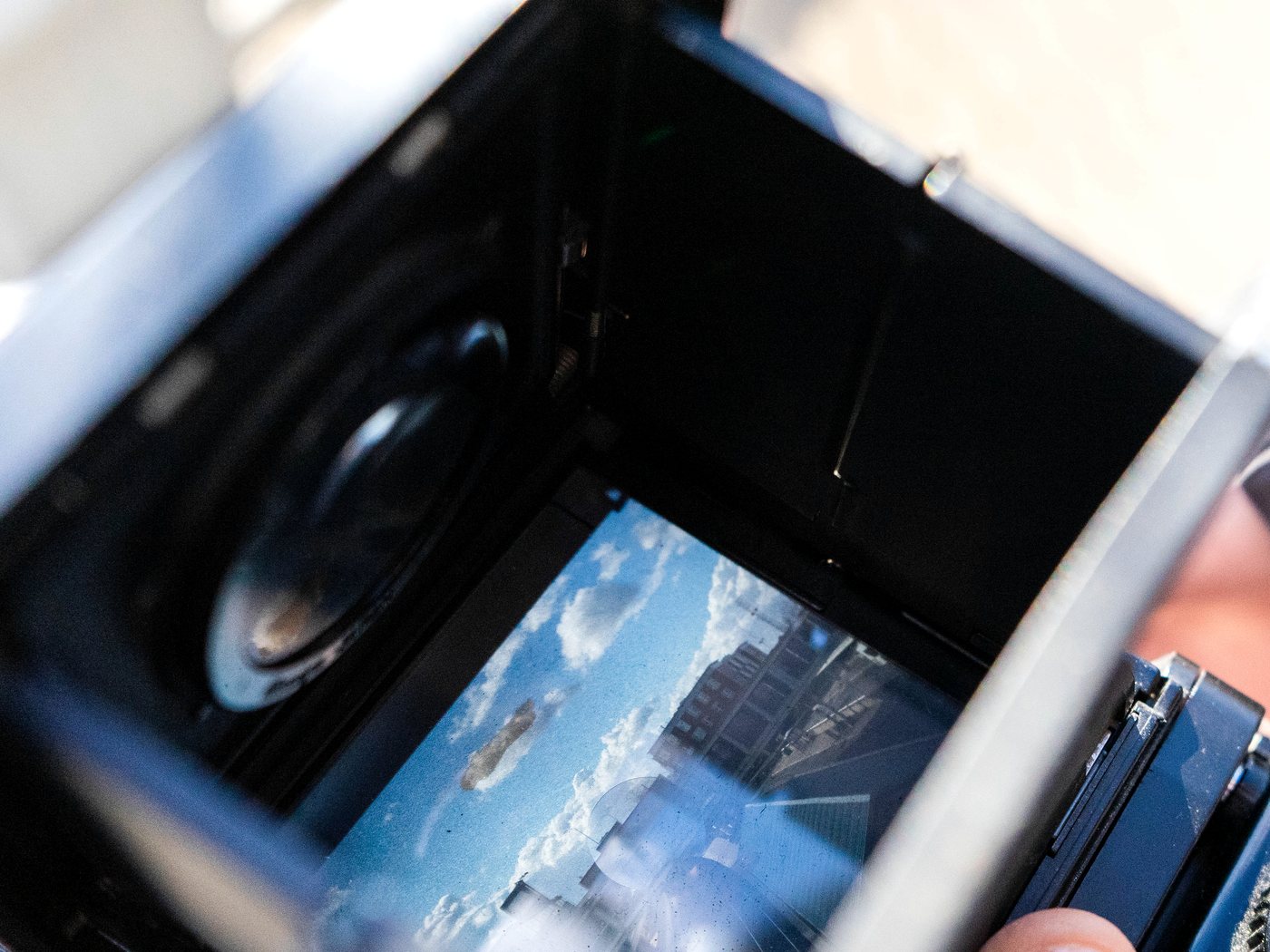 Looking down into the viewfinder of a film camera