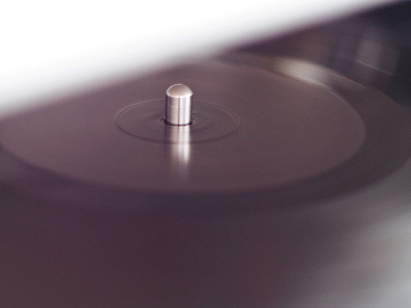 A record on the platter of a turntable in the listening room